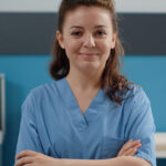 portrait of woman working as medical assistant at desk